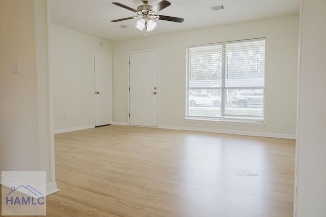 empty room with ceiling fan and light wood-type flooring