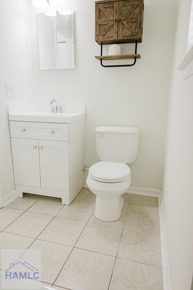 bathroom with tile patterned floors, vanity, and toilet