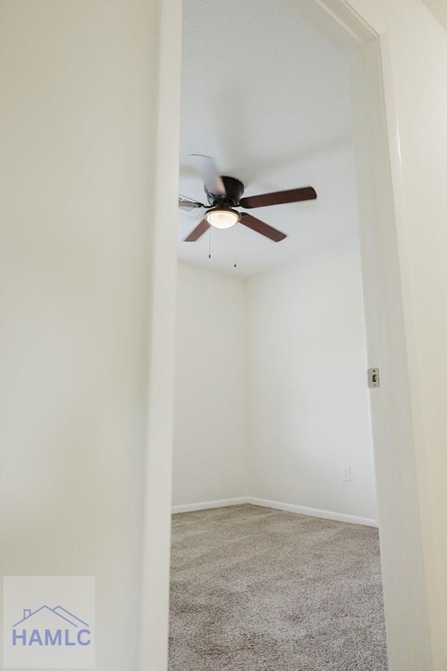 spare room featuring carpet floors and ceiling fan