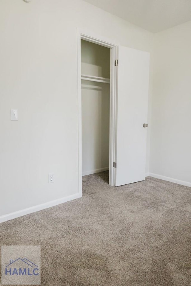 unfurnished bedroom featuring a closet and carpet floors