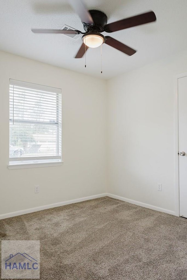 carpeted empty room featuring ceiling fan