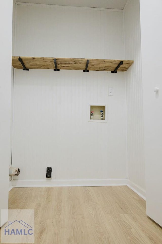 laundry area featuring washer hookup and light hardwood / wood-style floors