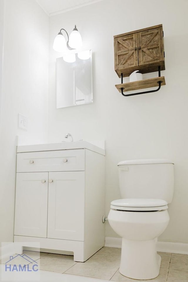 bathroom featuring tile patterned floors, vanity, and toilet