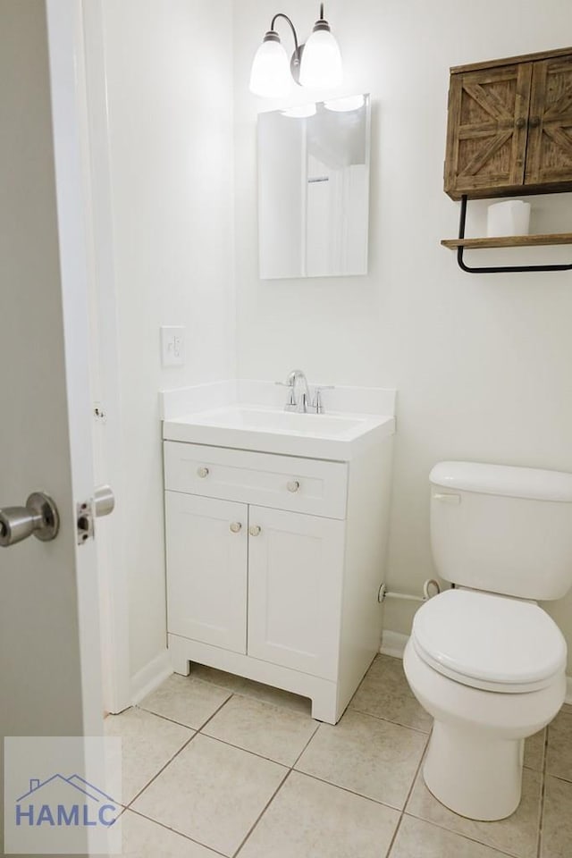 bathroom with tile patterned floors, vanity, and toilet