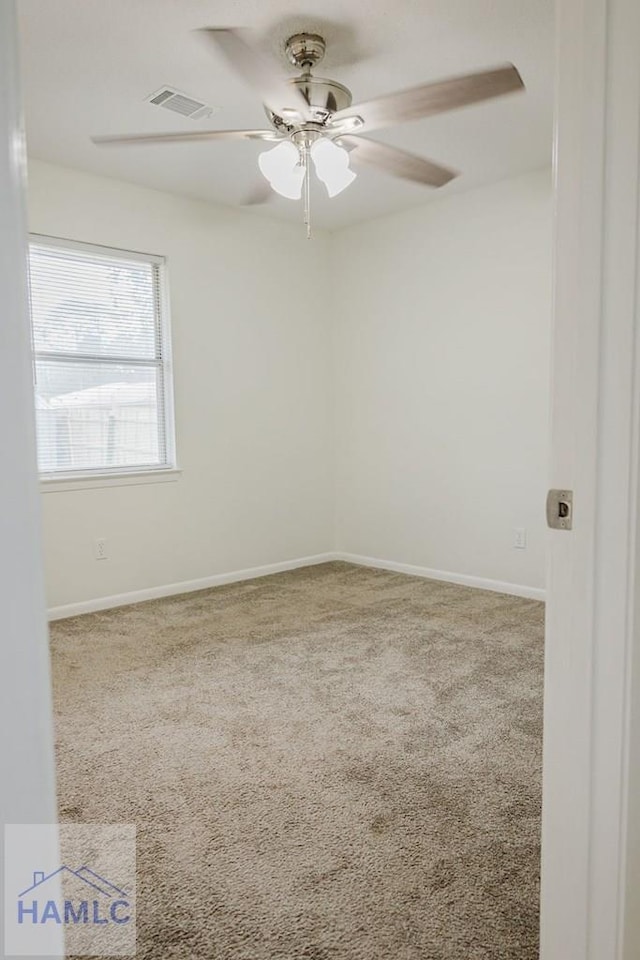 spare room with carpet flooring and ceiling fan