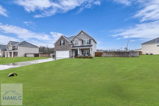 view of front of home with a garage, a front yard, driveway, and fence