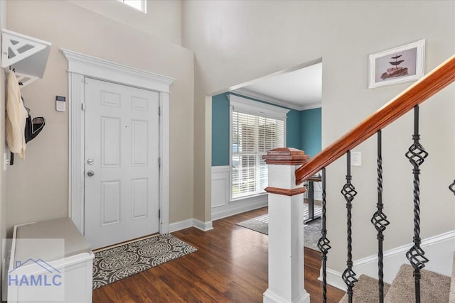 foyer featuring crown molding and dark hardwood / wood-style floors