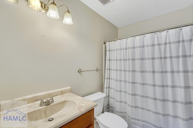 bathroom featuring vanity, a notable chandelier, a textured ceiling, and toilet