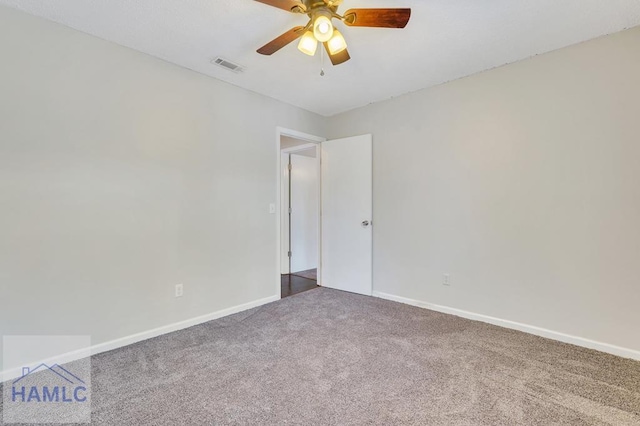 carpeted spare room featuring ceiling fan