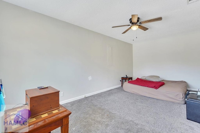 bedroom featuring ceiling fan, carpet floors, and a textured ceiling