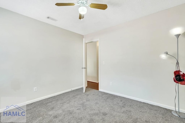 spare room featuring ceiling fan and carpet floors