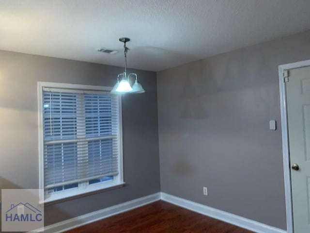 unfurnished dining area featuring dark wood-type flooring