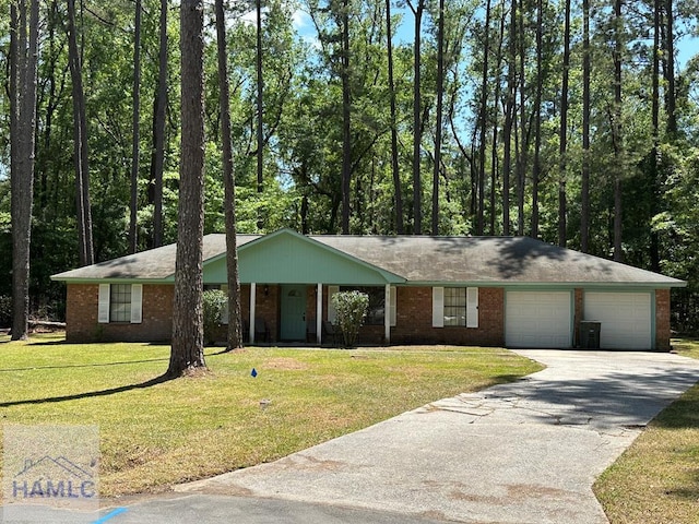 ranch-style home with a front yard, an attached garage, and brick siding