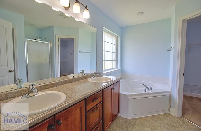 bathroom featuring vanity, separate shower and tub, and tile patterned floors