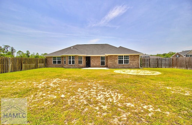 back of house with a lawn and a patio area