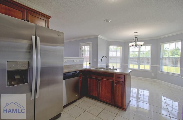 kitchen featuring a chandelier, stainless steel appliances, a wealth of natural light, and sink