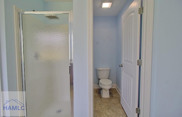 bathroom featuring an enclosed shower and toilet