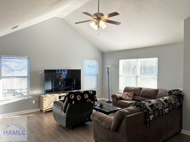 living room featuring wood-type flooring, a textured ceiling, ceiling fan, and a healthy amount of sunlight