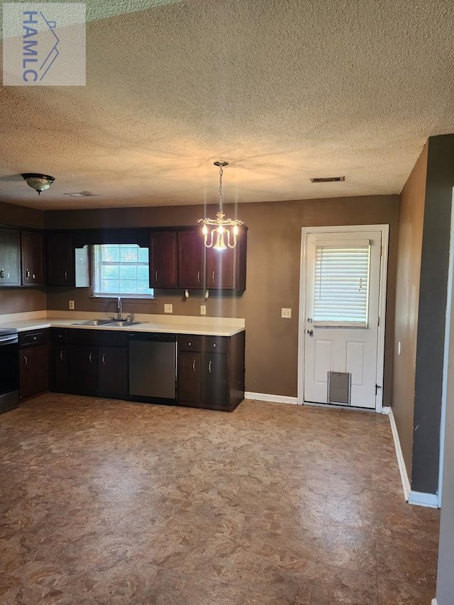1302 Loblolly Dr, Hinesville, GA 31313 - kitchen featuring appliances with stainless steel finishes, light countertops, tile patterned floors, a textured ceiling, and pendant lighting