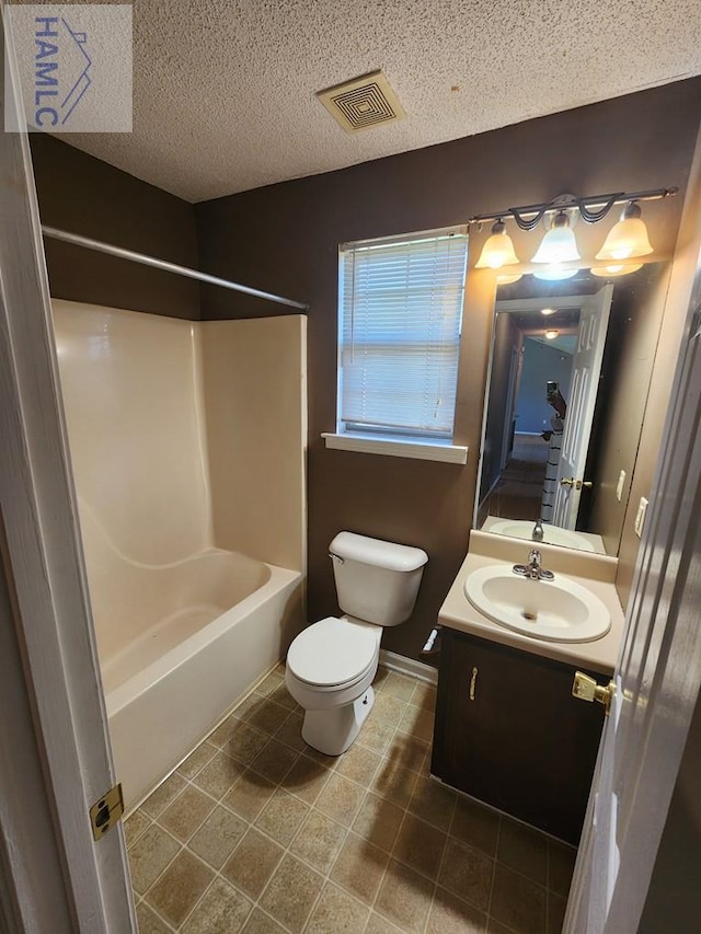 1302 Loblolly Dr, Hinesville, GA 31313 - bathroom with vanity, shower / washtub combination, tile patterned floors, and a textured ceiling