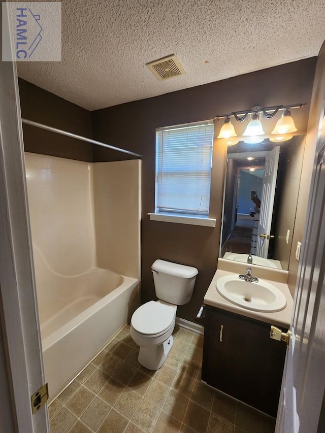 1302 Loblolly Dr, Hinesville, GA 31313 - full bathroom featuring vanity, tub / shower combination, tile patterned flooring, and a textured ceiling