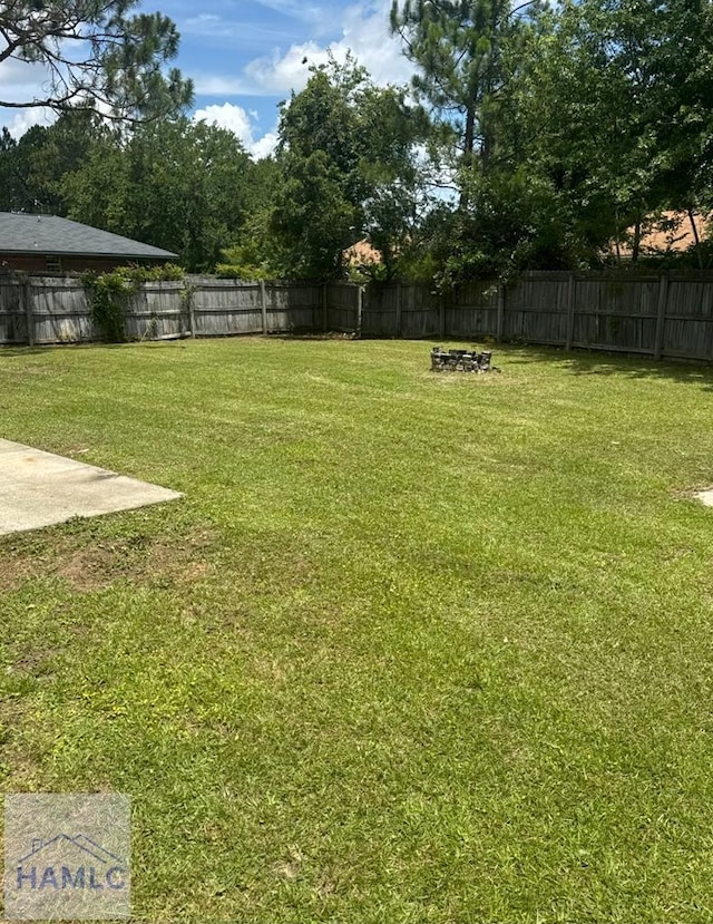 1302 Loblolly Dr, Hinesville, GA 31313 - fenced backyard with a fire pit