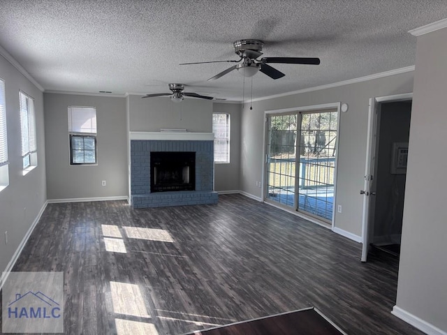 unfurnished living room featuring a brick fireplace, ceiling fan, crown molding, and dark hardwood / wood-style flooring