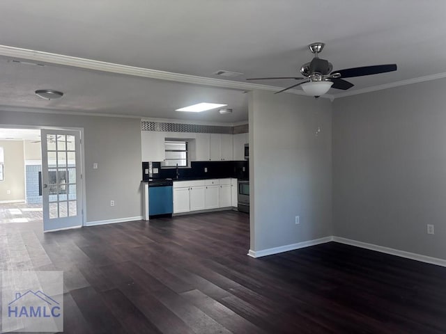 kitchen with dark wood-type flooring, stainless steel appliances, backsplash, crown molding, and white cabinetry