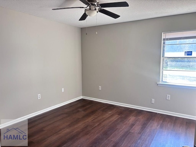 empty room with a textured ceiling, dark hardwood / wood-style flooring, and ceiling fan