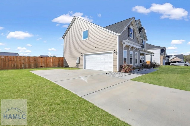 view of side of property featuring a yard, an attached garage, fence, and driveway