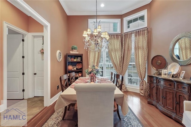 655 Littlefield St, Jesup, GA 31546 - dining area with baseboards, a notable chandelier, crown molding, and light wood-style floors