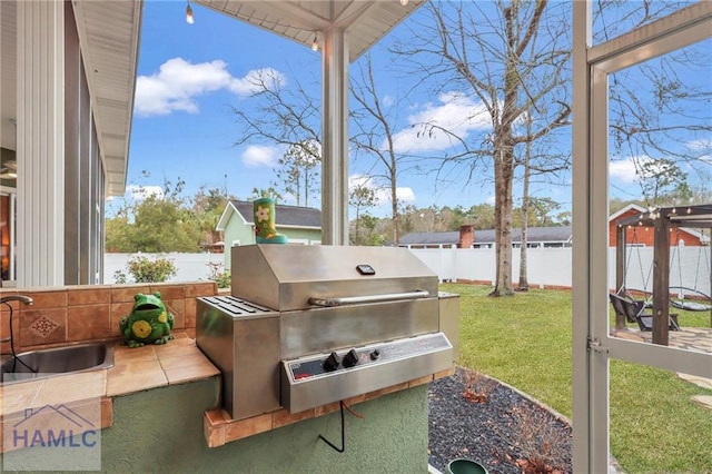 655 Littlefield St, Jesup, GA 31546 - exterior space with area for grilling, a fenced backyard, and a sink