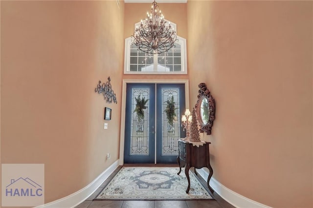 655 Littlefield St, Jesup, GA 31546 - entrance foyer with french doors, baseboards, tile patterned flooring, a chandelier, and a high ceiling