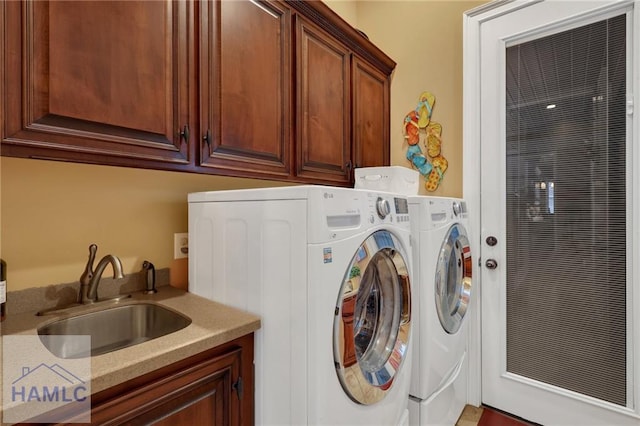 655 Littlefield St, Jesup, GA 31546 - clothes washing area featuring washer and dryer, cabinet space, and a sink