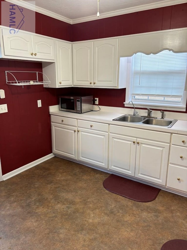 kitchen with sink, white cabinetry, and ornamental molding