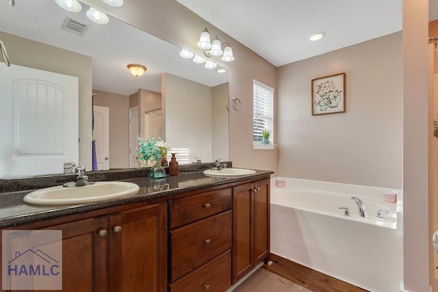 bathroom featuring vanity and independent shower and bath