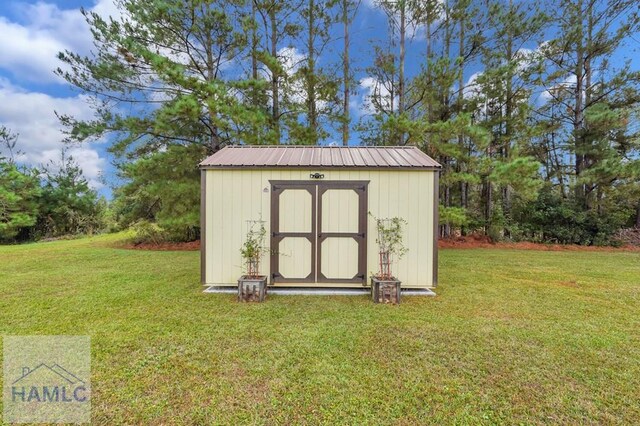 view of outbuilding featuring a yard