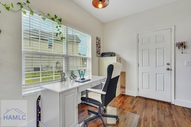 home office with dark hardwood / wood-style floors