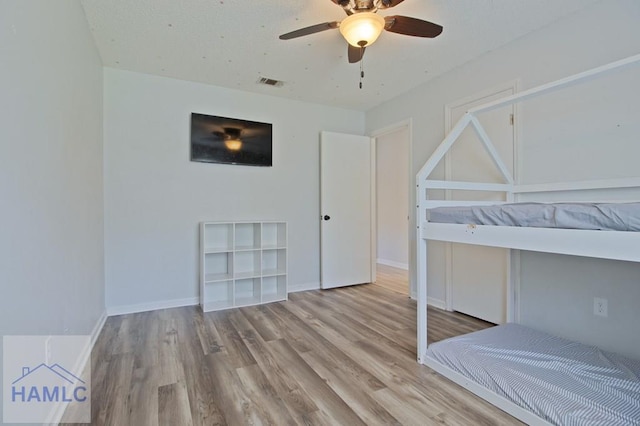 776 Madison Dr, Hinesville, GA 31313 - unfurnished bedroom with wood finished floors, baseboards, and ceiling fan