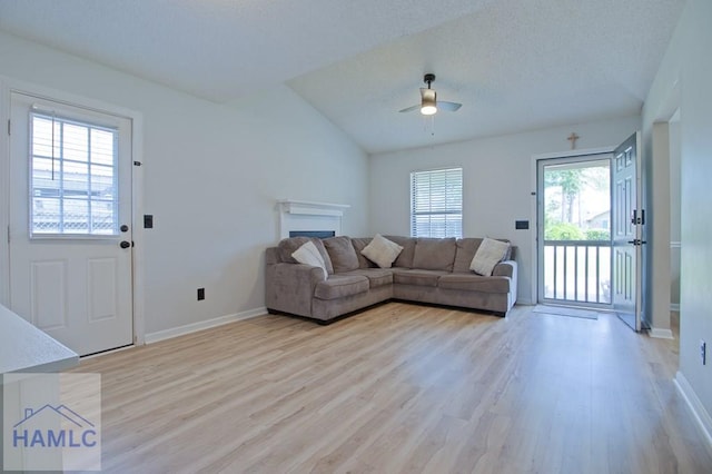 776 Madison Dr, Hinesville, GA 31313 - living area featuring light wood-style floors, baseboards, ceiling fan, and a fireplace