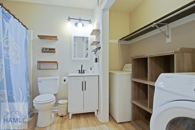 776 Madison Dr, Hinesville, GA 31313 - bathroom with washer / clothes dryer, wood finished floors, toilet, and vanity