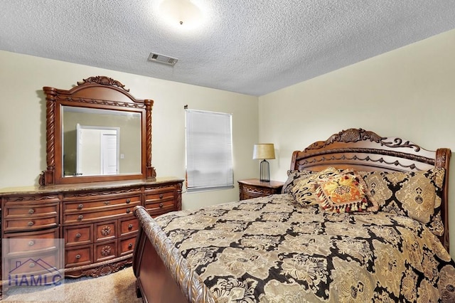 carpeted bedroom featuring a textured ceiling