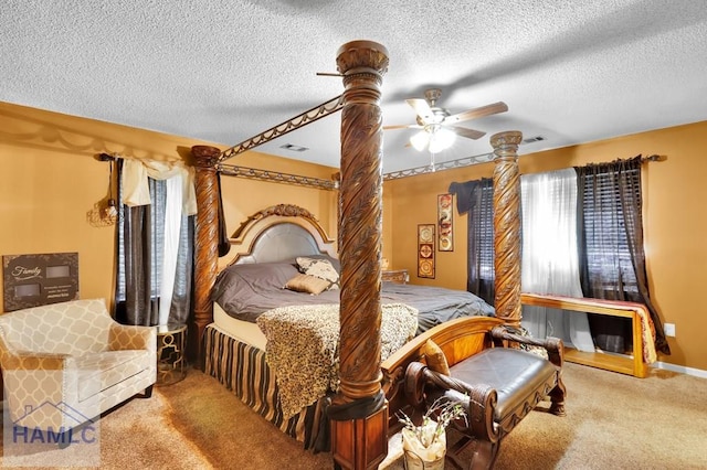 carpeted bedroom featuring ceiling fan and a textured ceiling