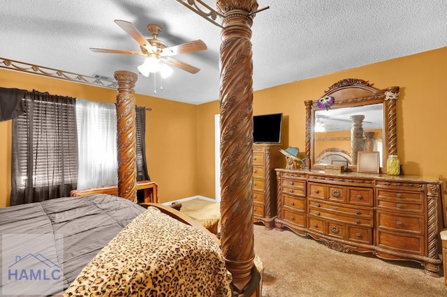 carpeted bedroom with a textured ceiling and ceiling fan