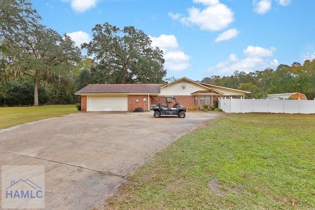 view of front of house featuring a garage and a front lawn