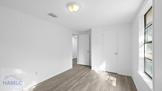 unfurnished bedroom with hardwood / wood-style floors and a closet