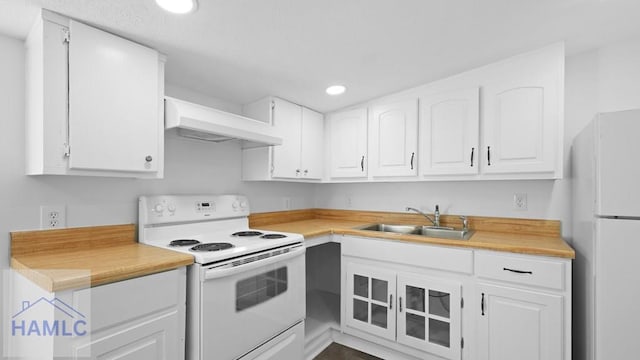 kitchen featuring premium range hood, white appliances, white cabinetry, and sink