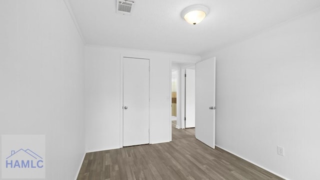 unfurnished bedroom featuring dark hardwood / wood-style floors