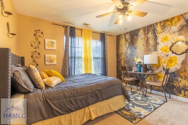 bedroom with carpet flooring, a ceiling fan, baseboards, visible vents, and wallpapered walls