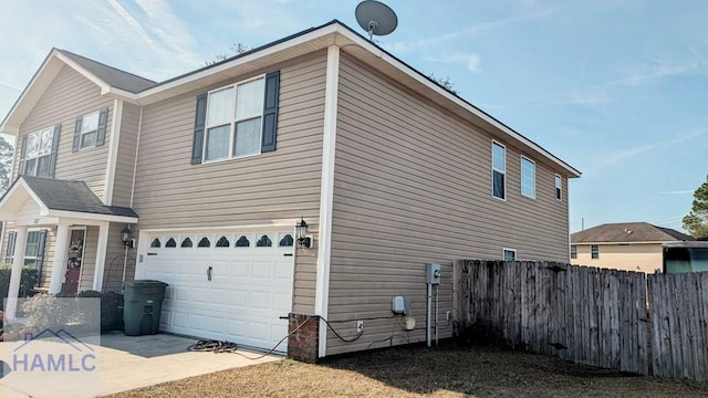 view of side of home featuring a garage